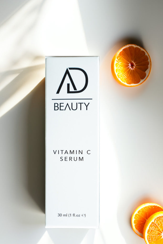 AD BEAUTY Vitamin C Serum Verpackung mit Orangenstücken – Symbolbild für natürliche Vitamin-C-Pflege